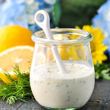 Jar of buttermilk dressing with fresh lemons in the background