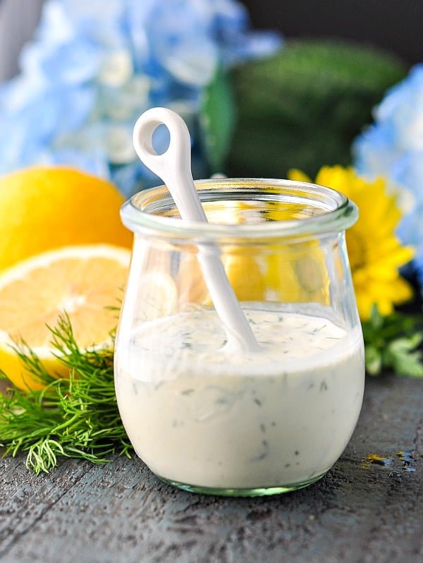 Jar of buttermilk dressing with fresh lemons in the background