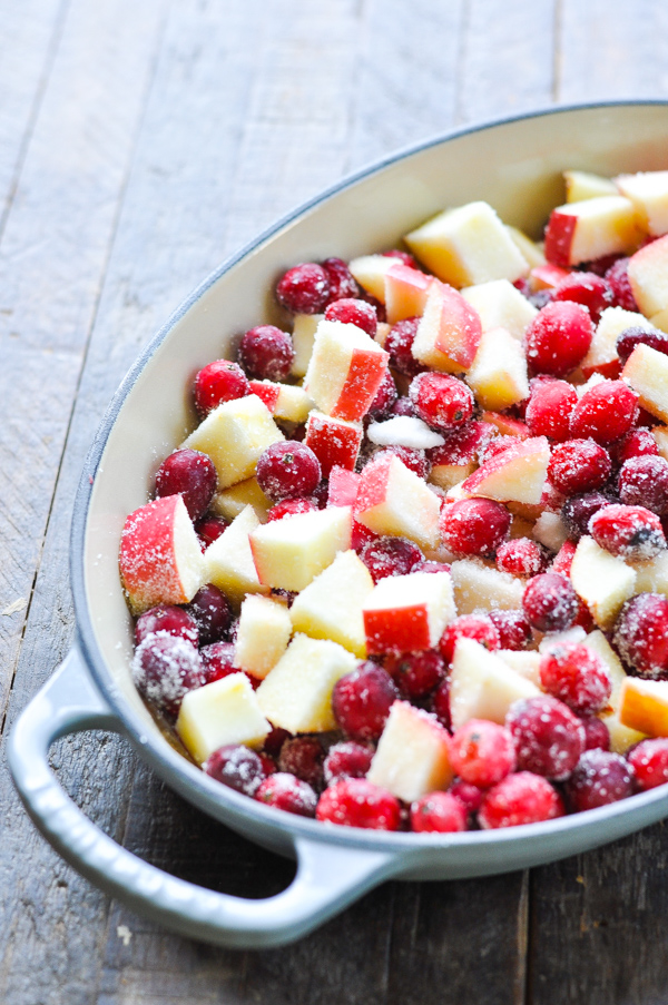 Raw cranberries and chopped apples in a baking dish