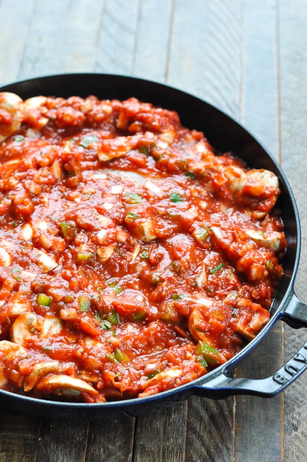 Chicken cacciatore in a skillet before baking