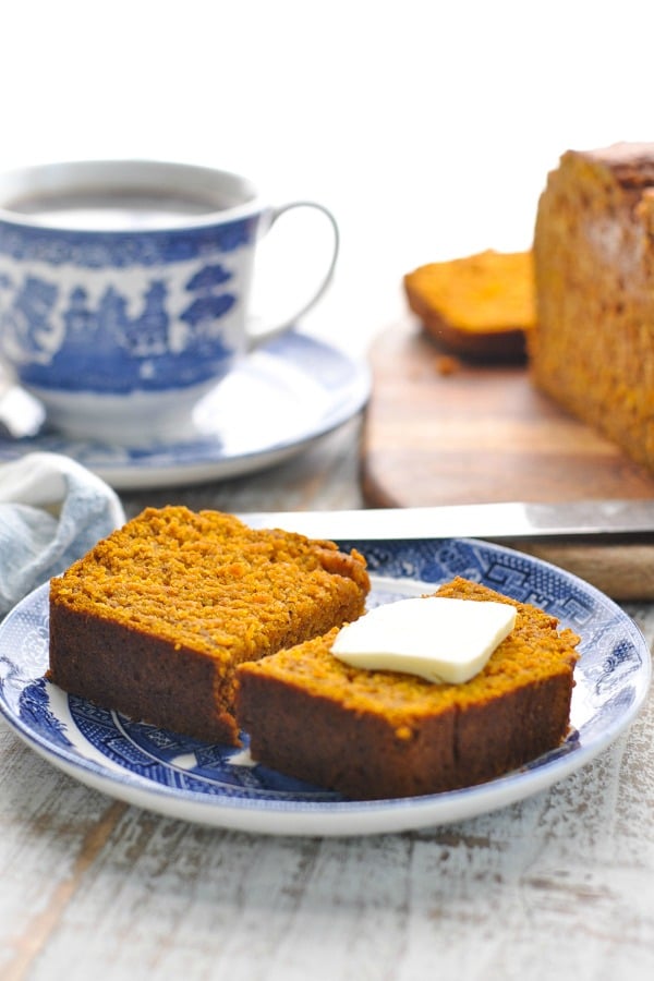 Front shot of pumpkin bread with butter on a plate