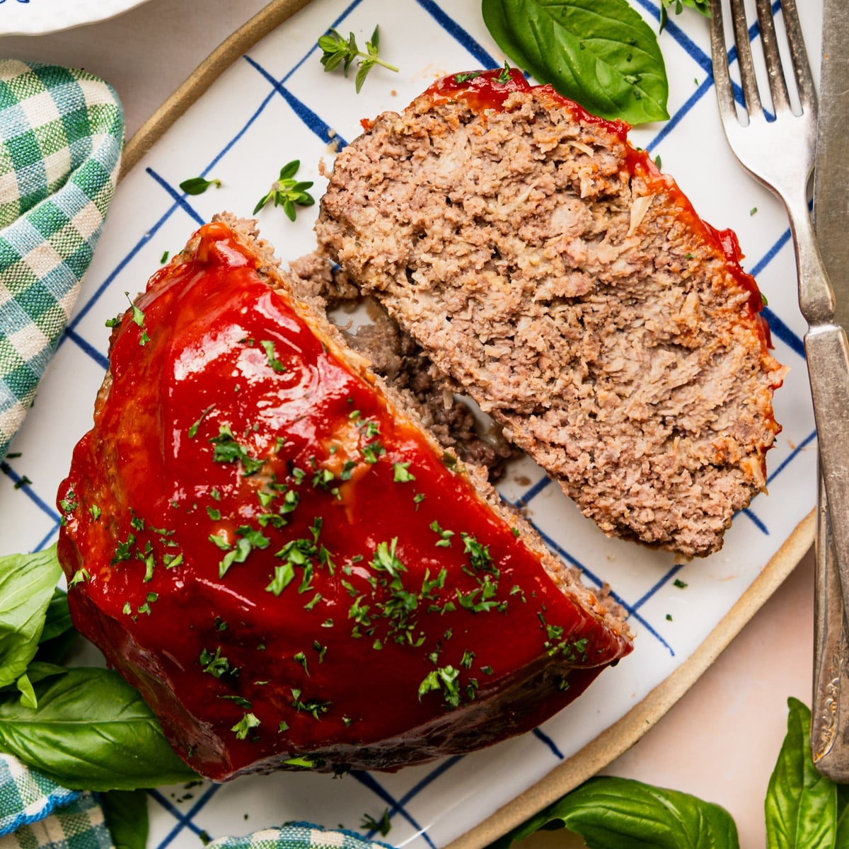Square overhead shot of a sliced crockpot meatloaf on a serving platter.