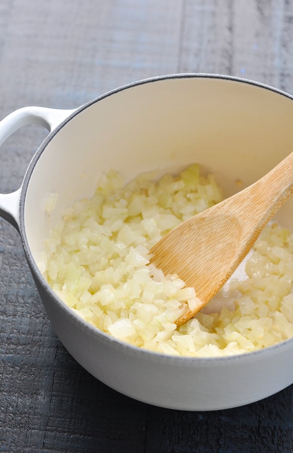 Diced onion and garlic in white pot