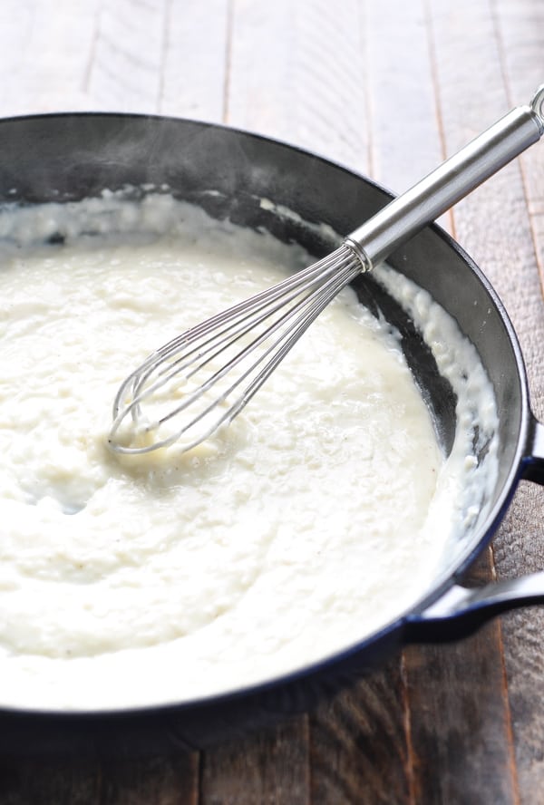 White sauce for creamed spinach in a cast iron skillet