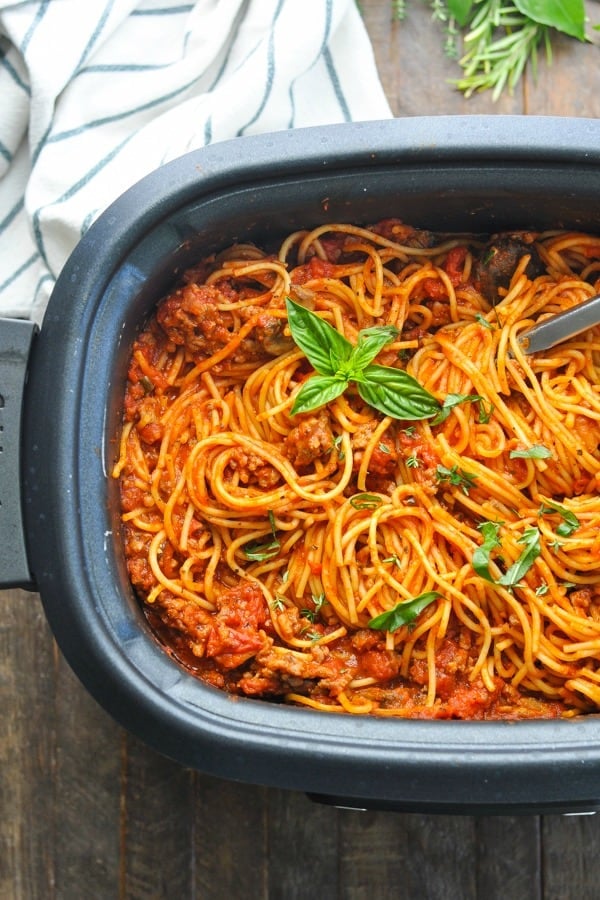 Overhead shot of crock pot spaghetti with italian sausage in a slow cooker