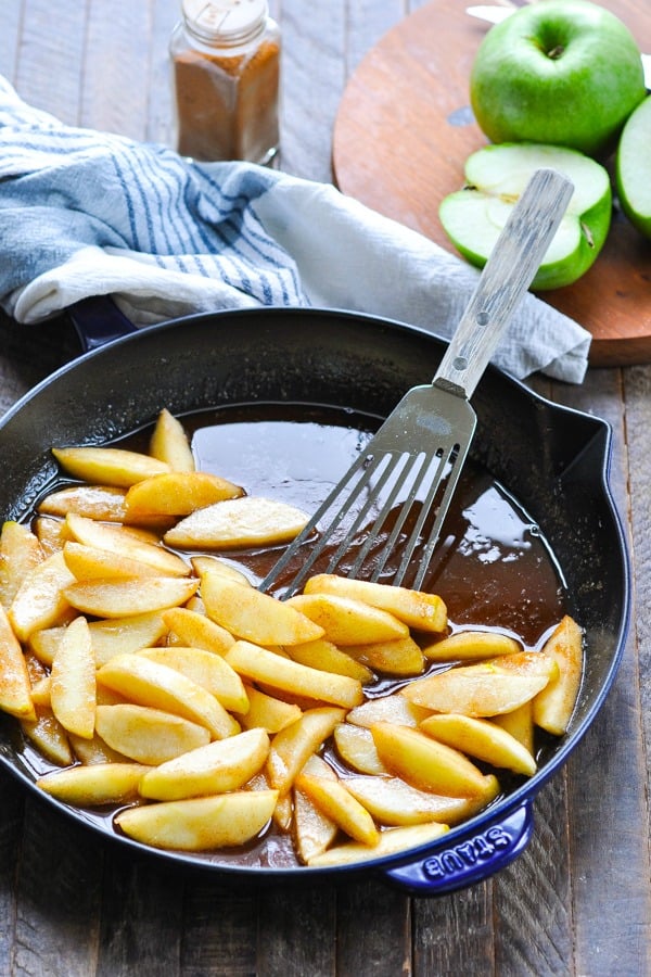 Fried apples with cinnamon in a cast iron skillet