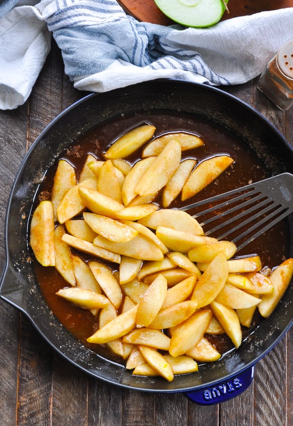 Long overhead shot of fried apples in a cast iron skillet