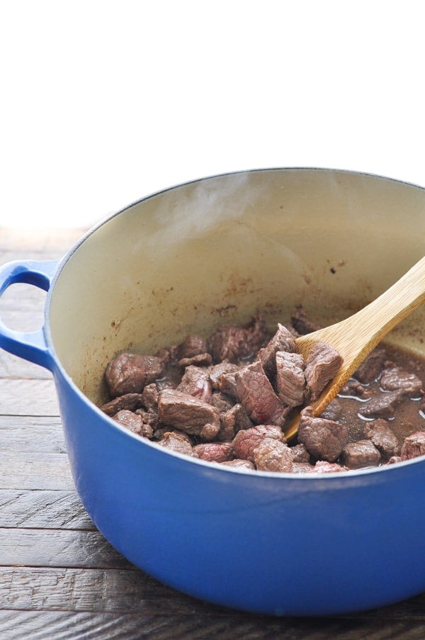 Browned stew beef in a large Dutch oven