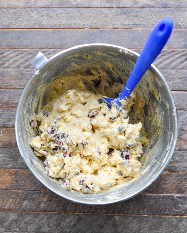 Overhead shot of blondies batter in a metal mixing bowl with spatula