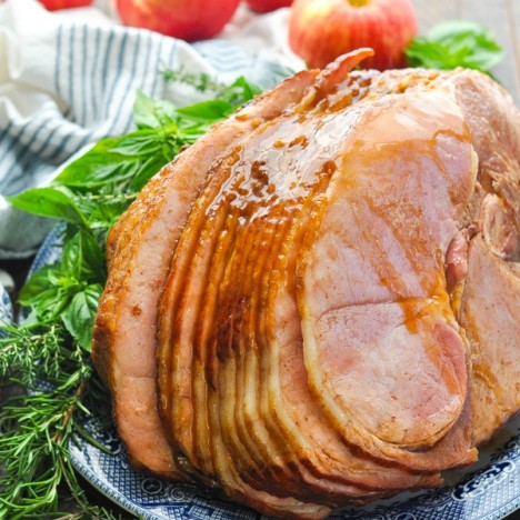 Front shot of Crock Pot Ham with Coke on a blue and white plate on a wooden surface