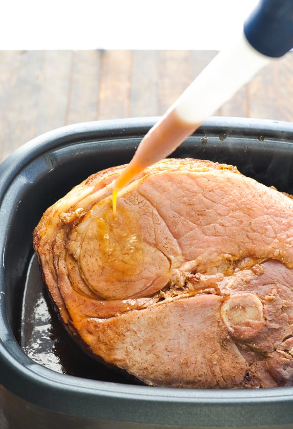 Basting Crock Pot ham with cola glaze
