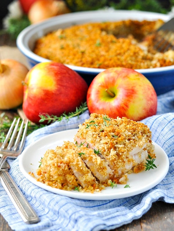 Boneless pork chops on a plate with apples and stuffing