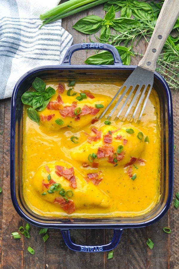 Overhead shot of ranch chicken with bacon in a blue casserole dish