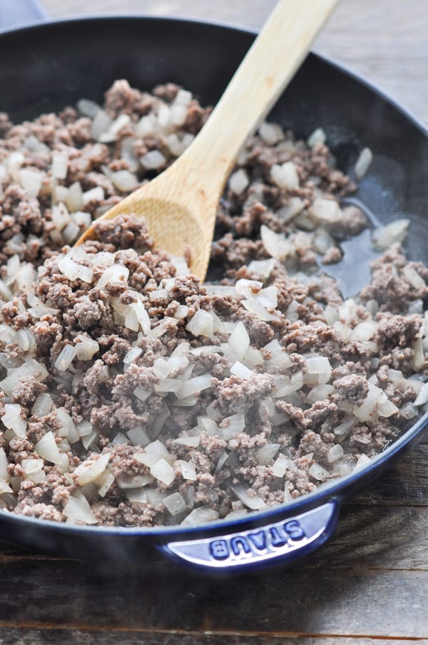 Ground beef and onion in a large cast iron skillet