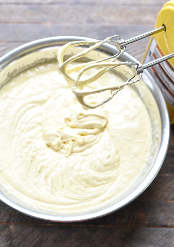 Batter for Honey Bun Cake in a mixing bowl with hand mixer