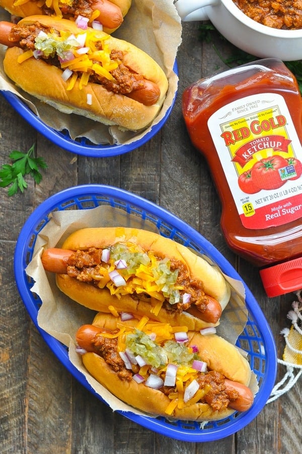 Overhead shot of chili dogs alongside a bottle of Red Gold ketchup
