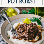 Close up side shot of a bowl of mashed potatoes with mississippi pot roast with text title box at top