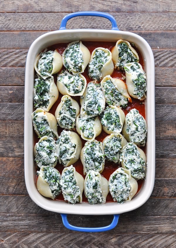 Overhead shot of spinach stuffed shells in a baking dish before oven