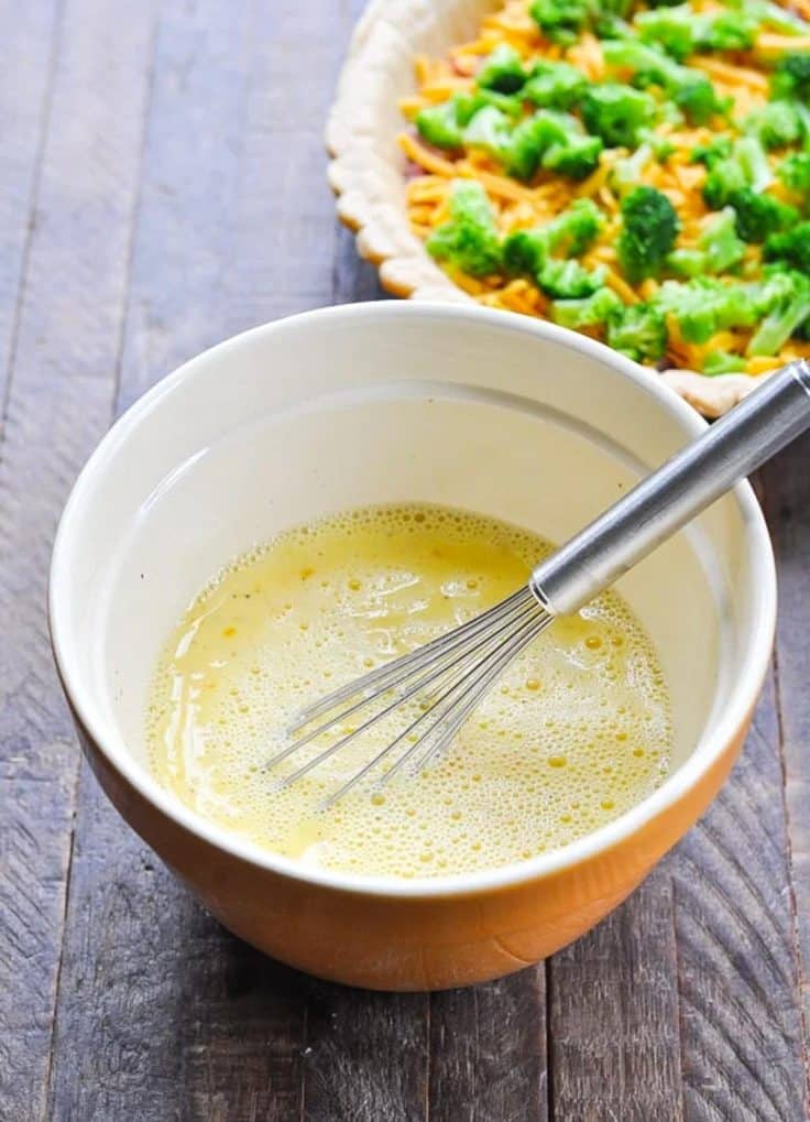 Whisking together egg mixture for quiche.