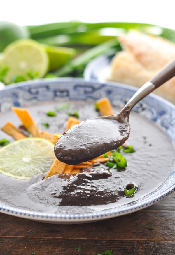 Close up shot of healthy vegan black bean soup on a spoon