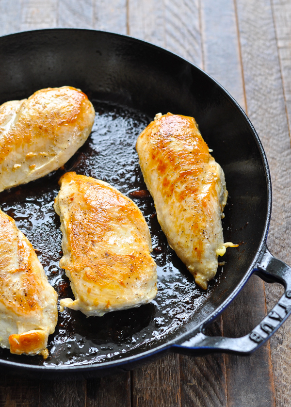 Pan fried chicken breasts in a cast iron skillet