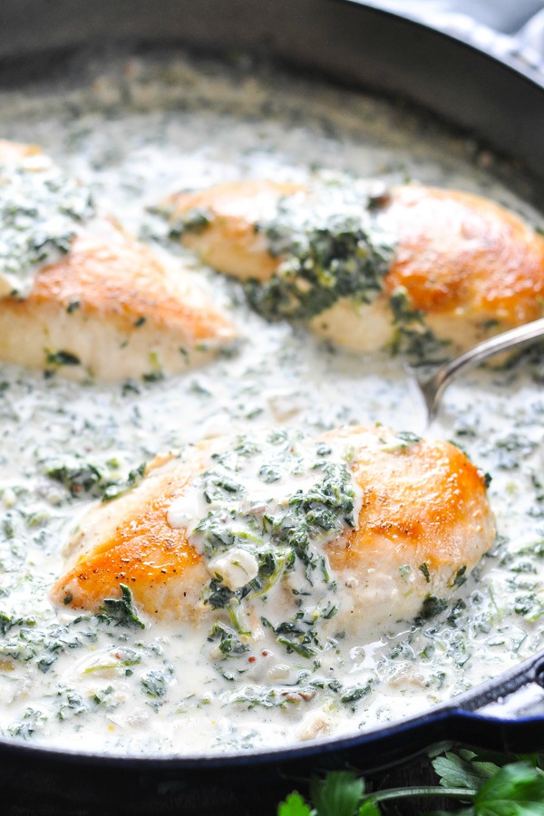 Close up front shot of chicken florentine in a cast iron skillet
