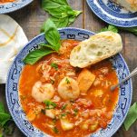 Close overhead shot of a bowl of cioppino recipe with fresh seafood