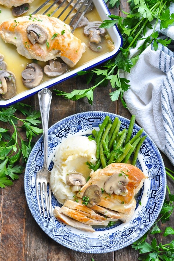 Long overhead shot of slow cooker chicken and mushrooms with gravy on a plate