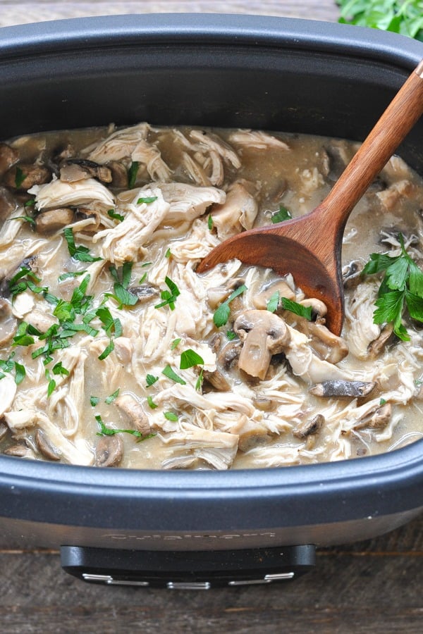 Crock Pot Chicken and Mushrooms recipe in a slow cooker with fresh parsley on top