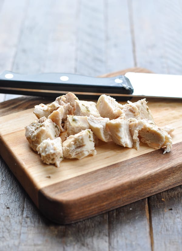 Diced chicken on a wooden cutting board