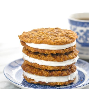 Close up front shot of three oatmeal cream pies stacked on a small plate