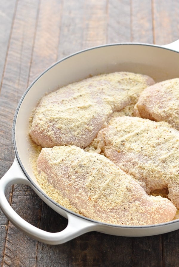 Parmesan crusted chicken breasts in a dish before baking