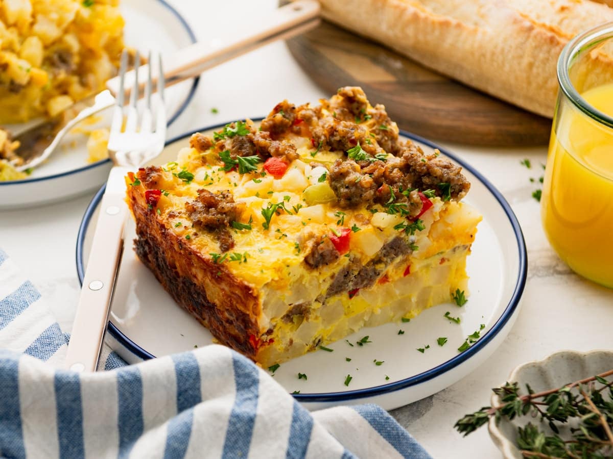 Horizontal side shot of a slice of Crock Pot breakfast casserole on a plate.