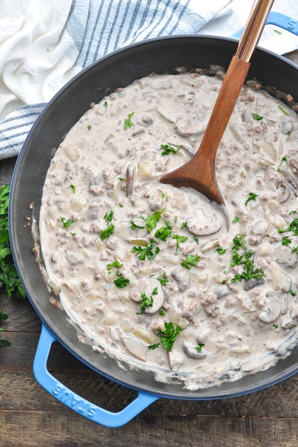 Long overhead shot of ground beef stroganoff sauce in a large cast iron skillet