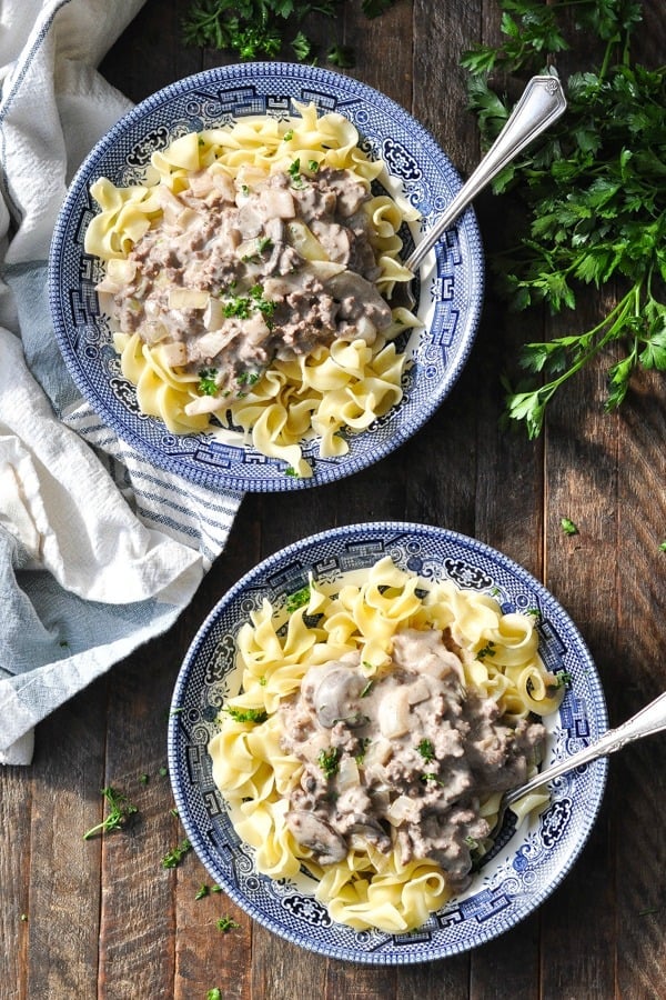 Overhead shot of two bowls of ground beef stroganoff with noodles
