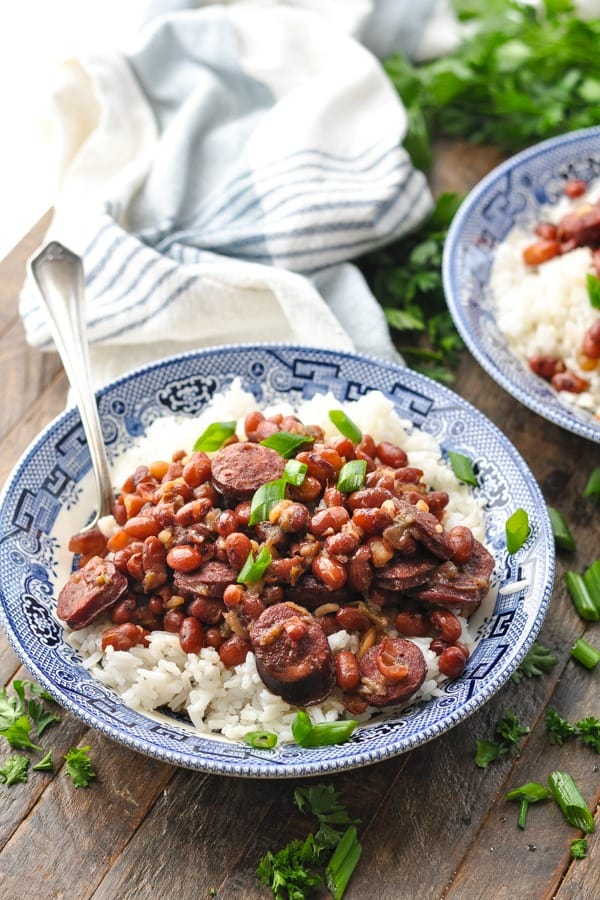 Front shot of a bowl of easy instant pot red beans and rice garnished with sliced green onion