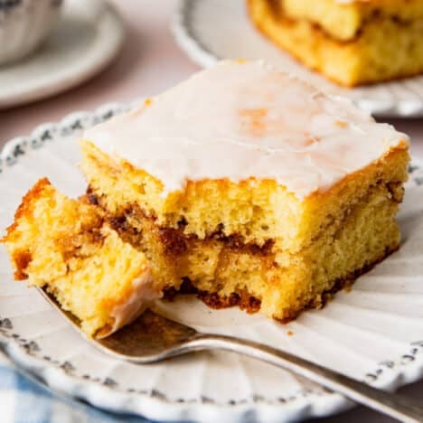 Square side shot of a slice of honey bun cake on a plate.