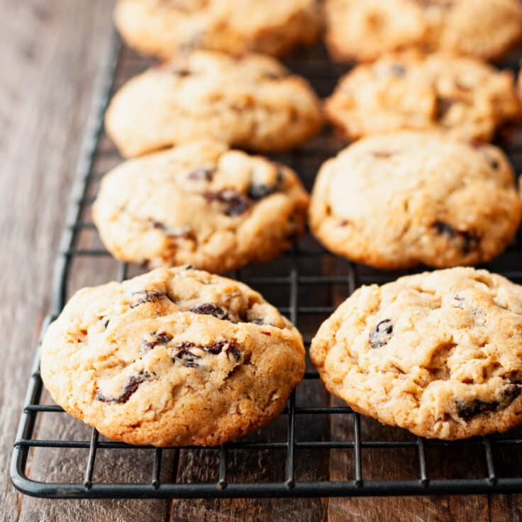 Oatmeal raisin cookies cooling on a wire rack.