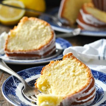Close front shot of lemon pound cake on a plate with a bite on a fork
