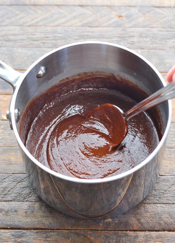 Stirring fudge icing for chocolate cherry cake