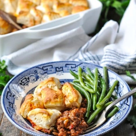 Sloppy Joe Casserole with biscuits on top served with green beans