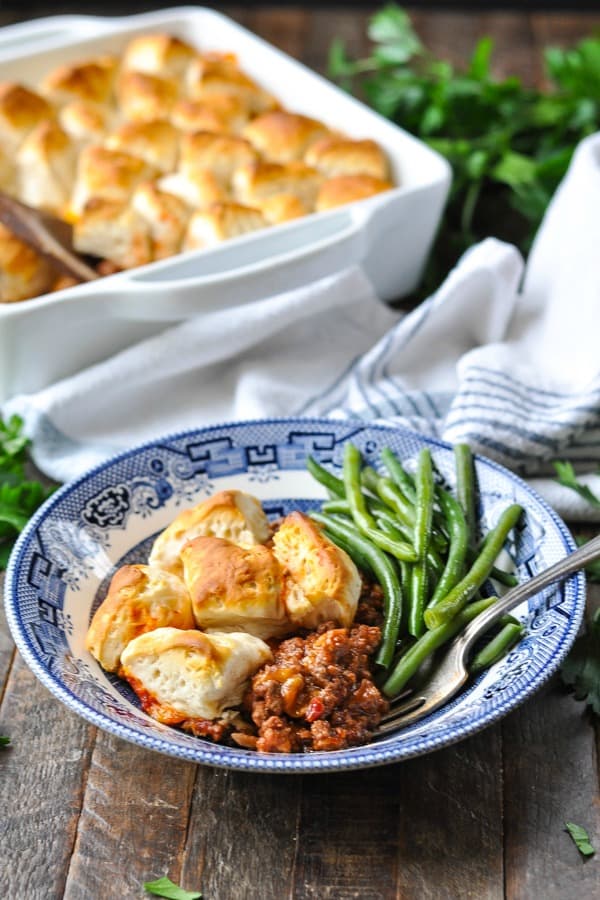 Sloppy Joe Casserole with biscuits on top served with green beans