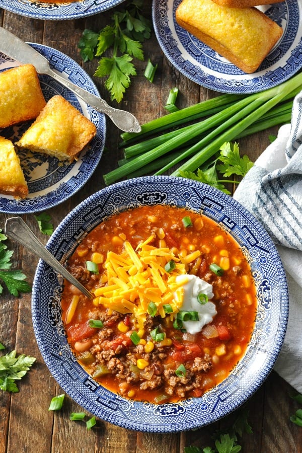 Close overhead shot of bowl of southern chili recipe on a wooden surface
