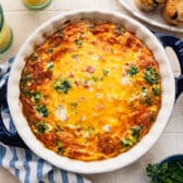 Square overhead image of a crustless spinach quiche in a pie plate.