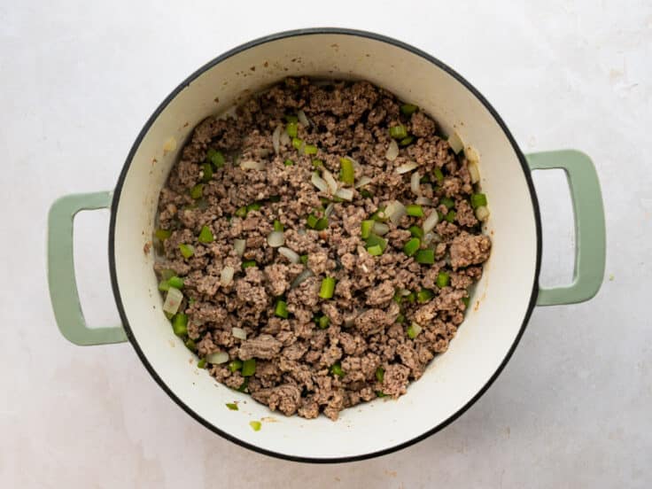 Browning sausage, ground beef, and veggies in a Dutch oven.