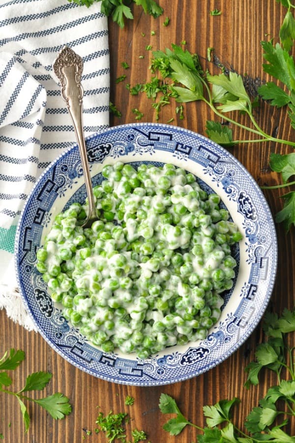 Overhead shot of a bowl of peas with cream sauce