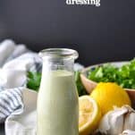 Bottle of green goddess dressing with text overlay