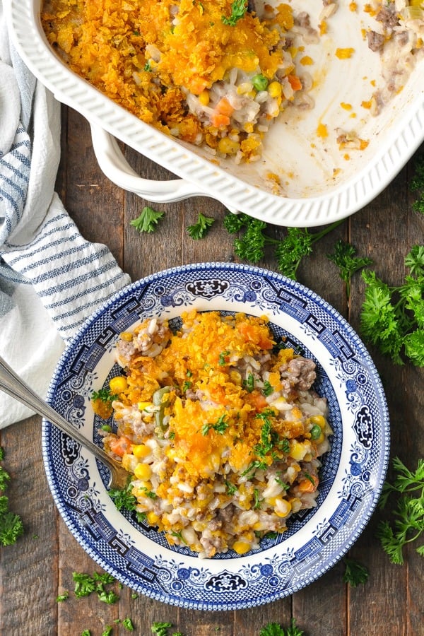 Cheesy ground beef casserole in a blue and white bowl on a table
