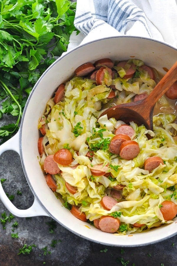 Overhead shot of pot of smoked polish sausage with cabbage