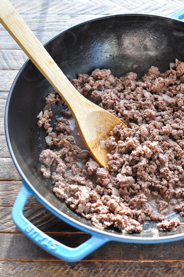 Browning ground beef with onion in a skillet